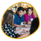 Three program participants sitting at a table